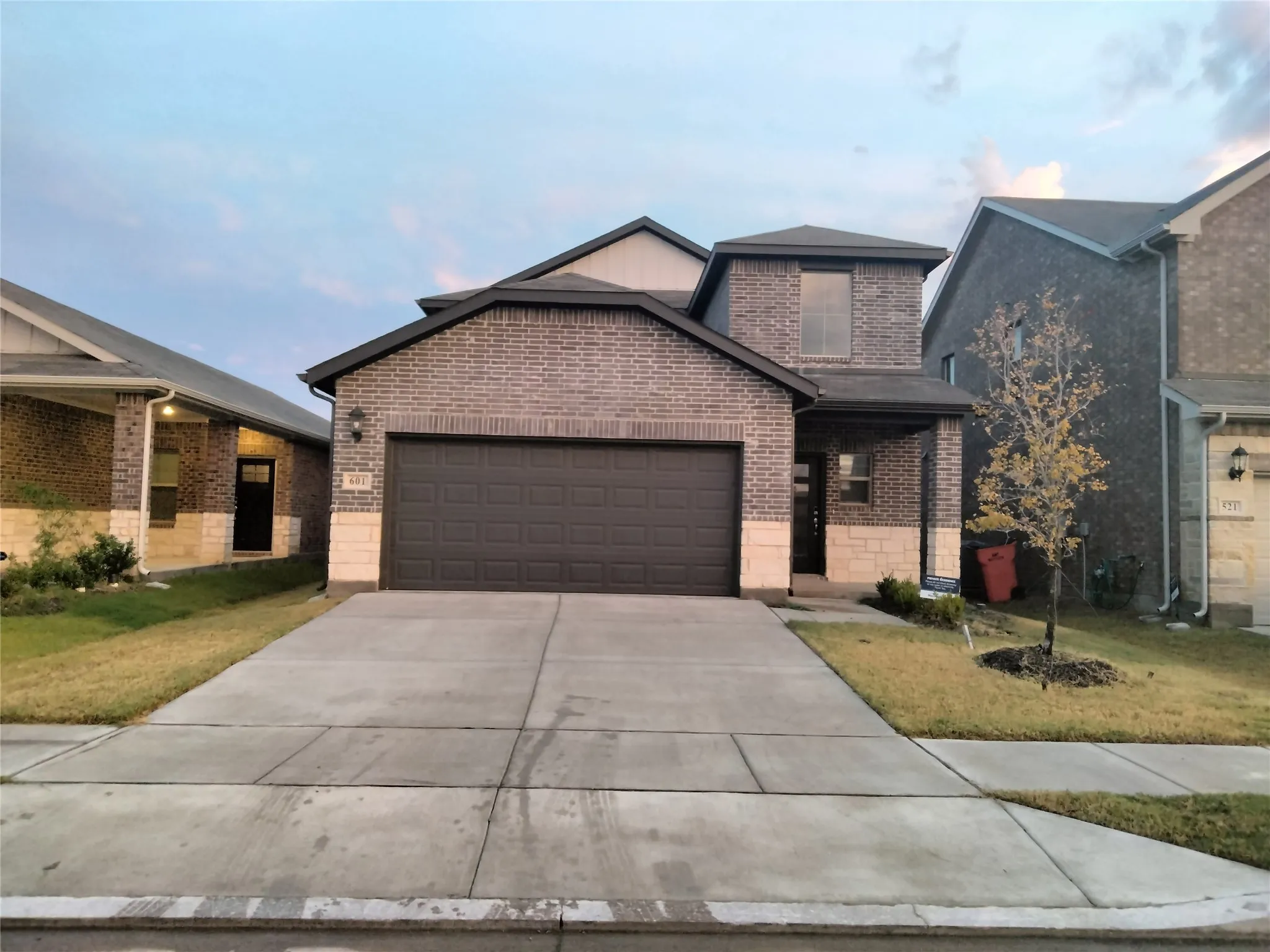 Brick and stone facade with an attached two-car garage