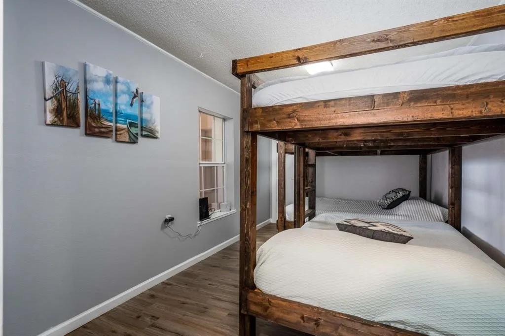Wood-finish flooring with white baseboards