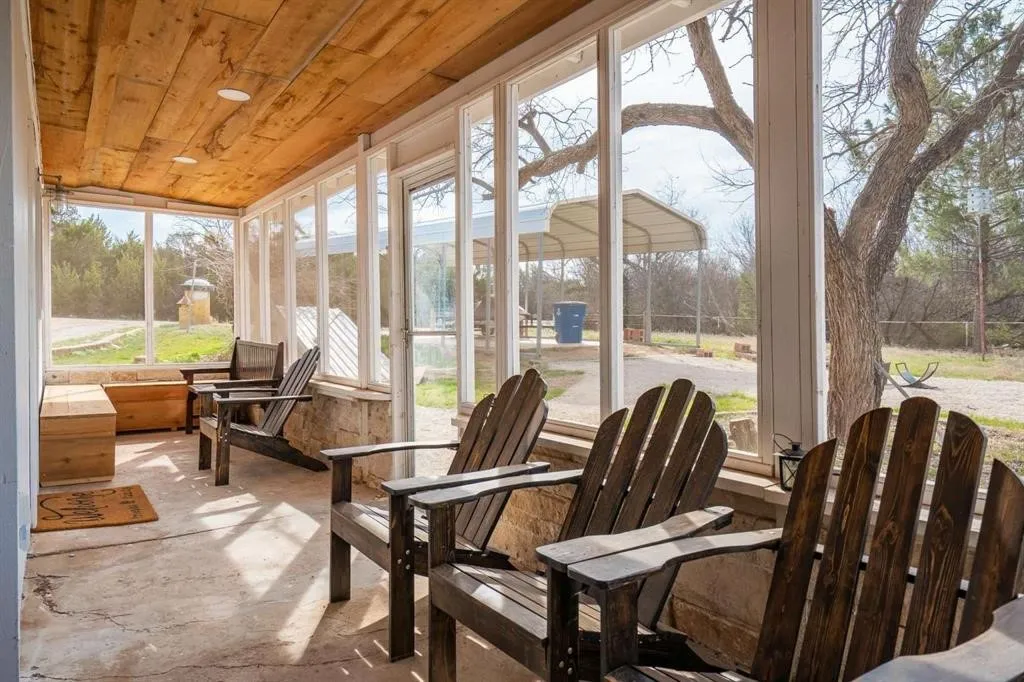 Screened porch featuring a wood-plank ceiling with recessed lighting and a concrete floor