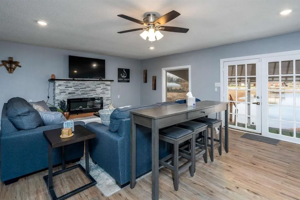 Recessed lighting, wood-finish flooring, a ceiling fan, and French doors with full-light panels