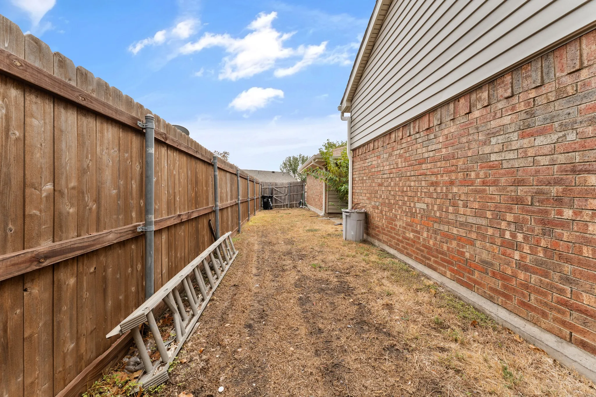 Wood privacy fence and brick exterior