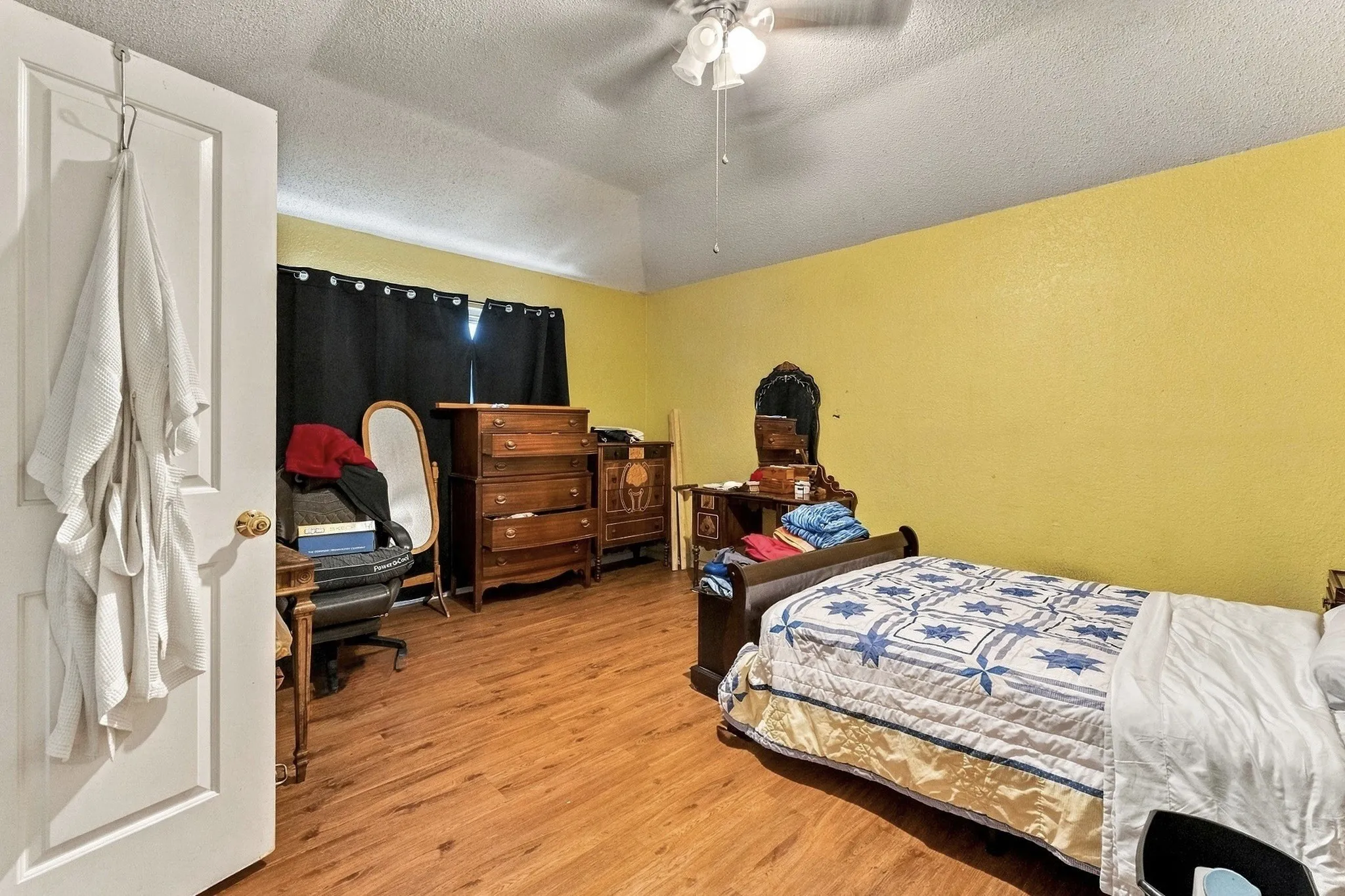 Wood-finish flooring, vaulted ceiling, and ceiling fan with lighting
