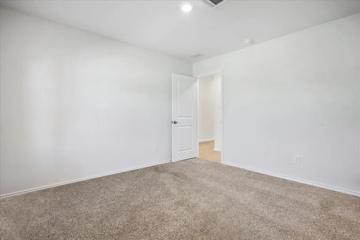 Neutral carpeting and white walls