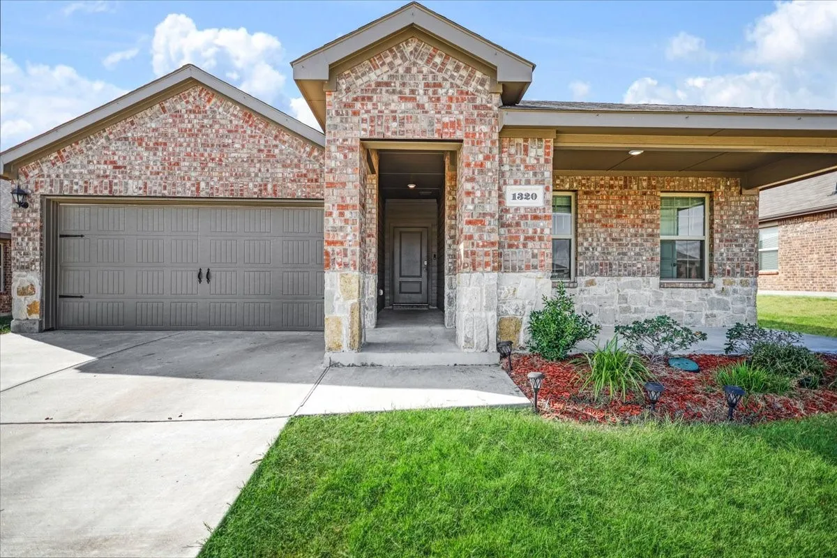 Brick and stone facade with an integrated two-car garage