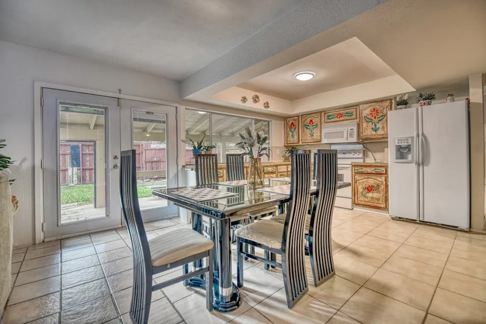 Tiled flooring, French doors, recessed ceiling lighting, and built-in cabinetry