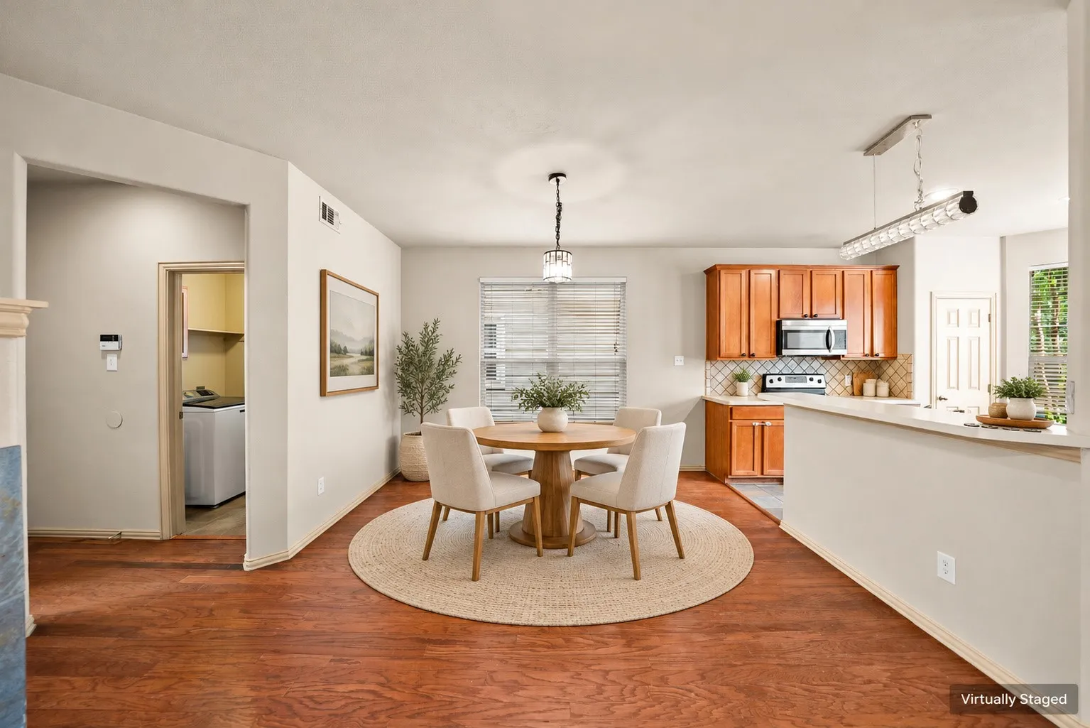 Wood-finish flooring throughout, bright kitchen with wood cabinetry, and a built-in microwave