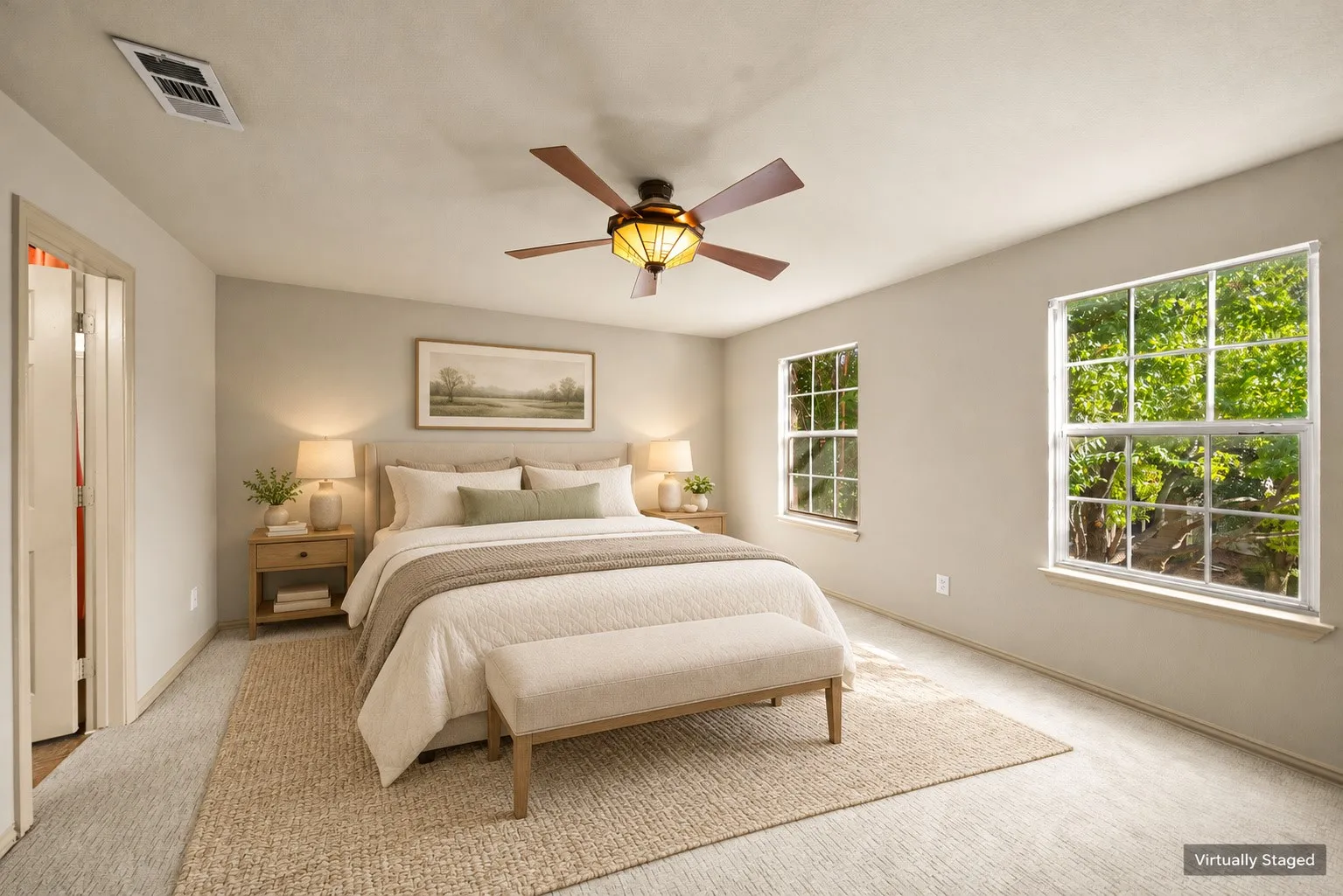 Carpeted flooring, two large windows, ceiling fan with integrated lighting, neutral wall tones, and a solid-core entry door