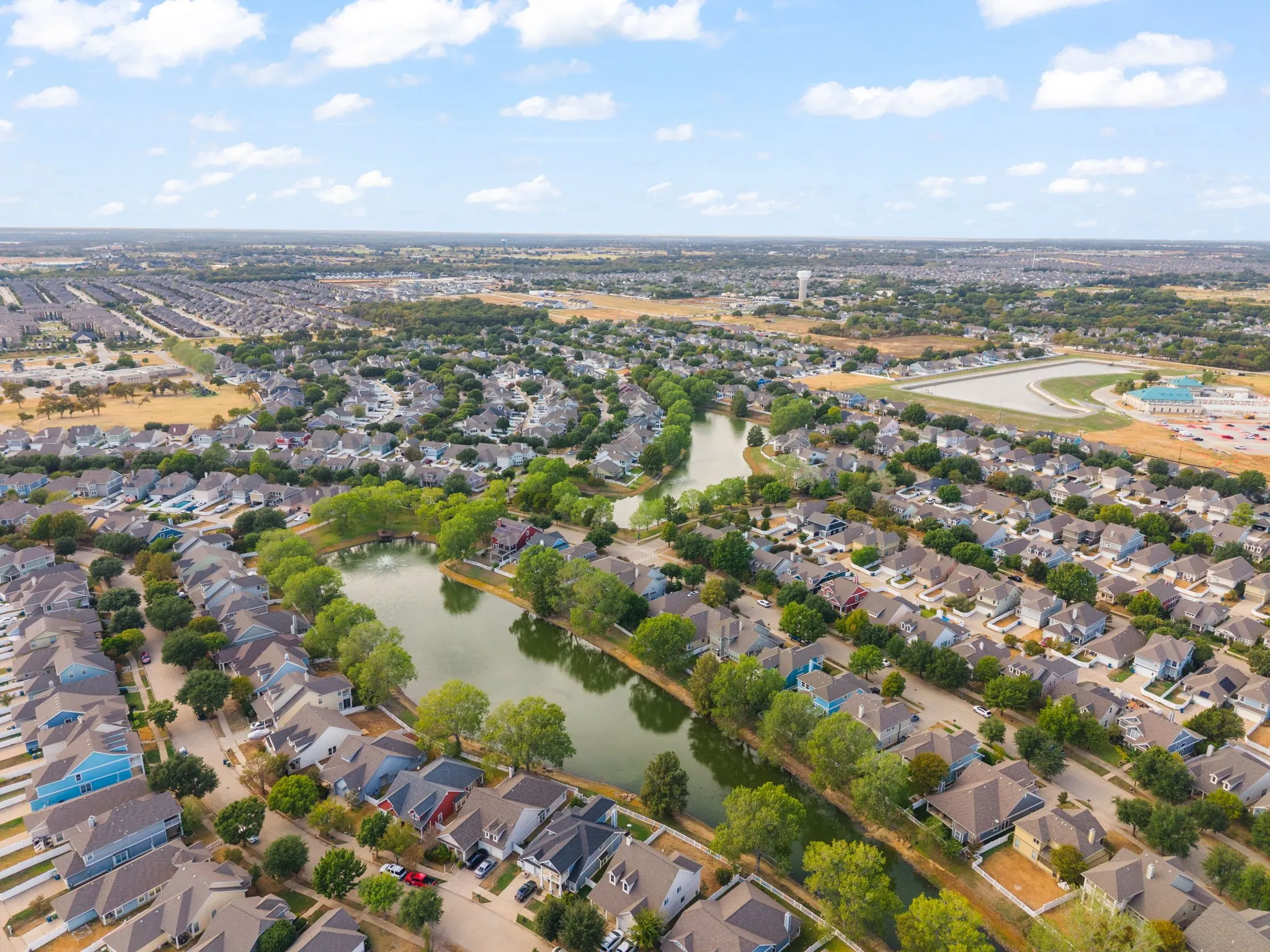 Residential development with extensive green landscaping and two prominent water features