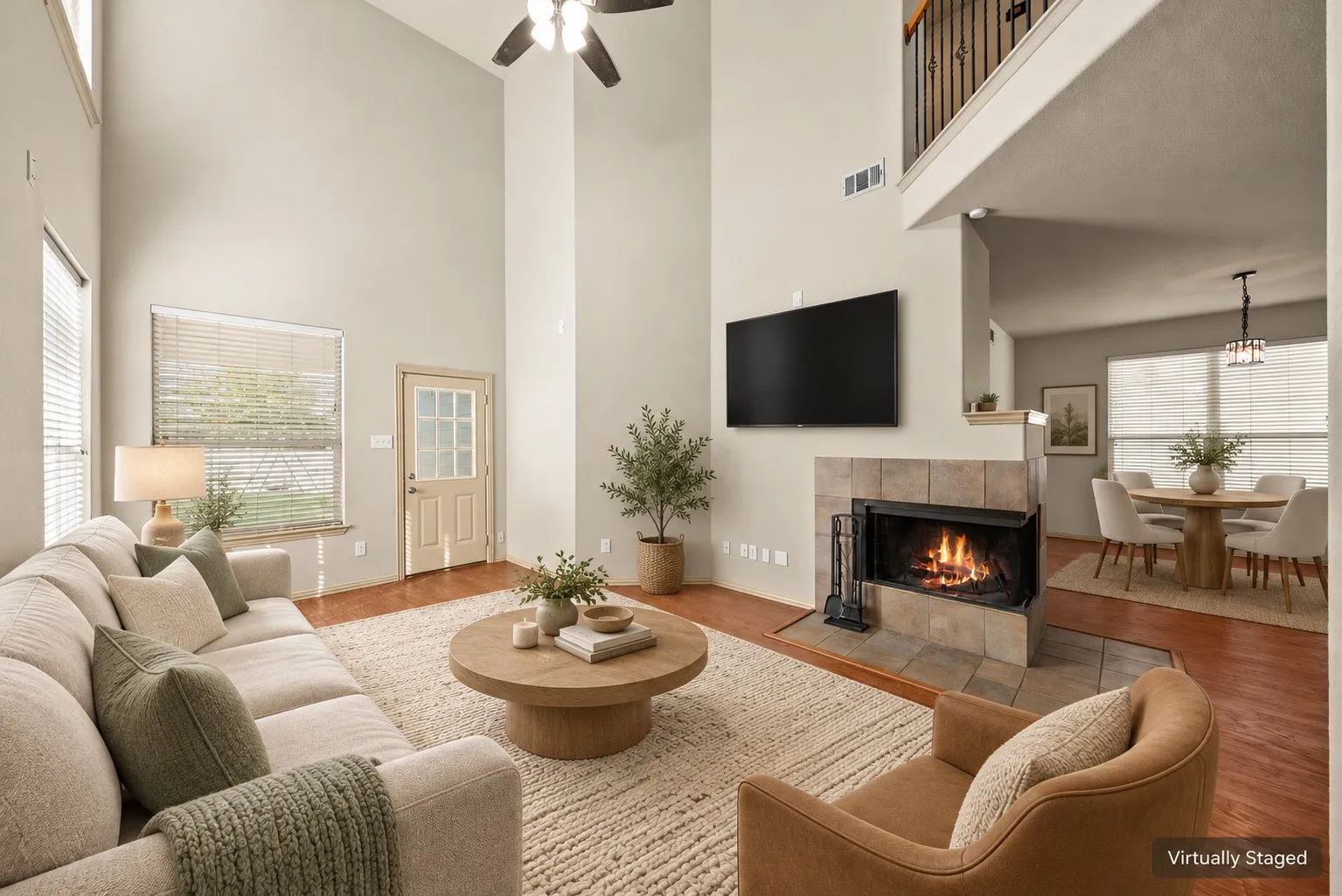 Vaulted ceilings, wood-finish flooring, and a tiled fireplace