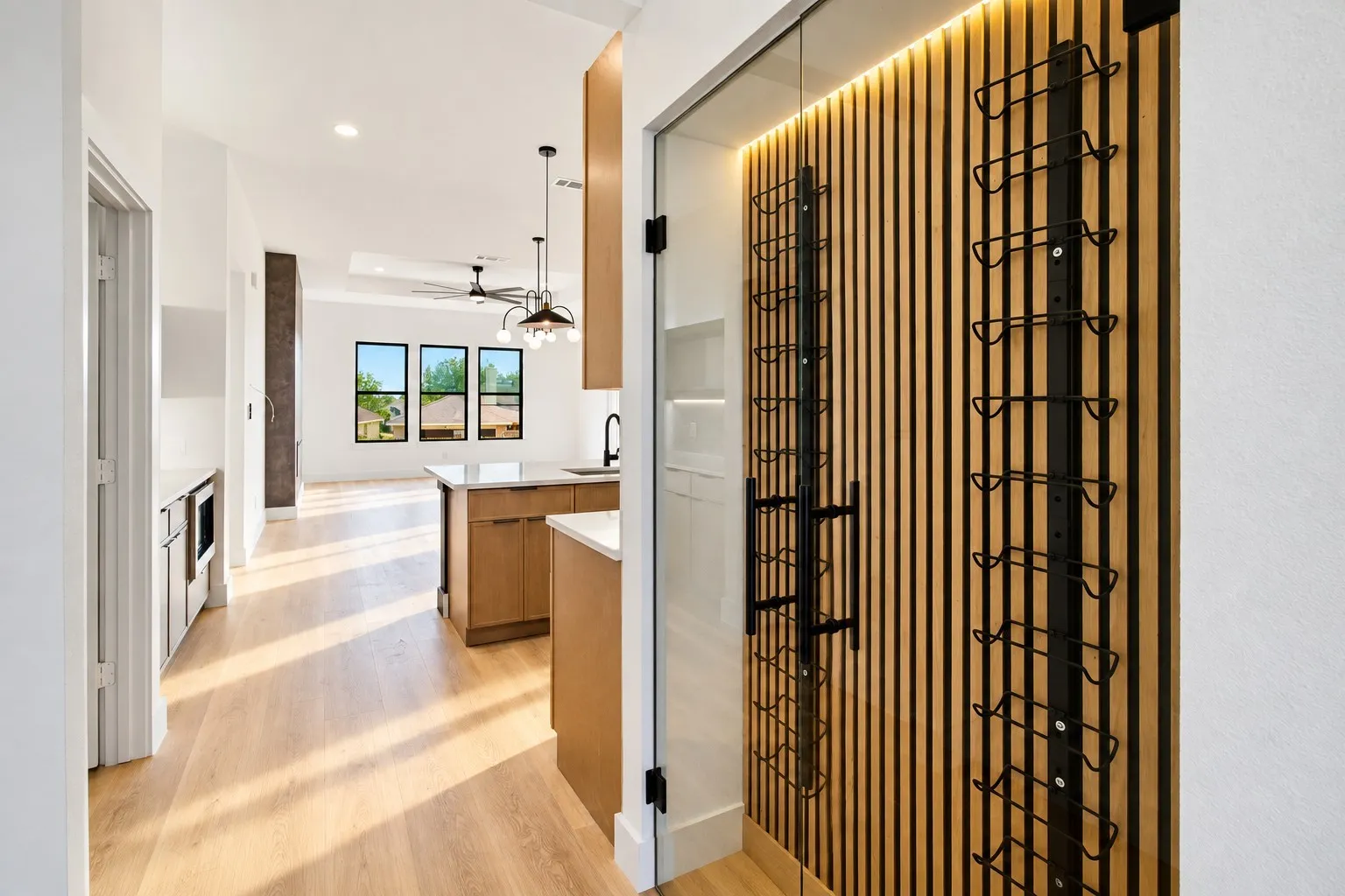 Built-in wine storage with wood-finish slat wall and integrated lighting