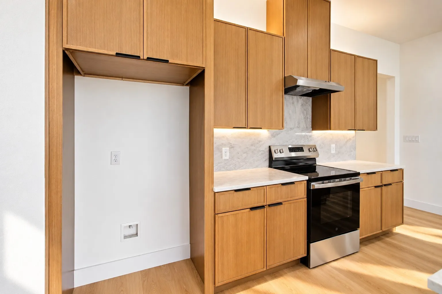 Kitchen featuring light wood-finish cabinetry with black hardware, stainless steel electric range, marble-patterned backsplash, under-cabinet lighting, and light wood-finish flooring