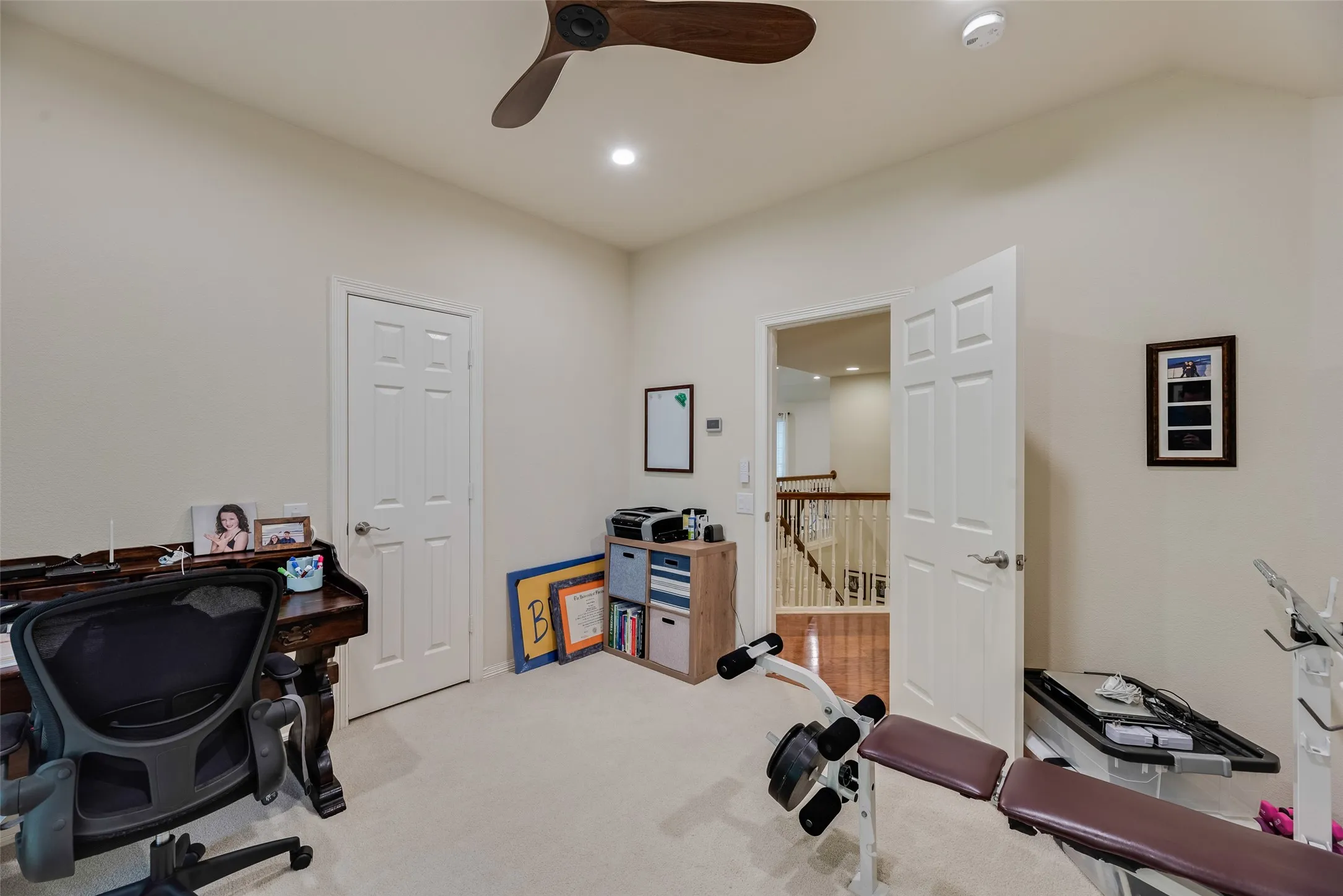 Vaulted ceiling with a wood-finish ceiling fan, recessed lighting, and carpet flooring
