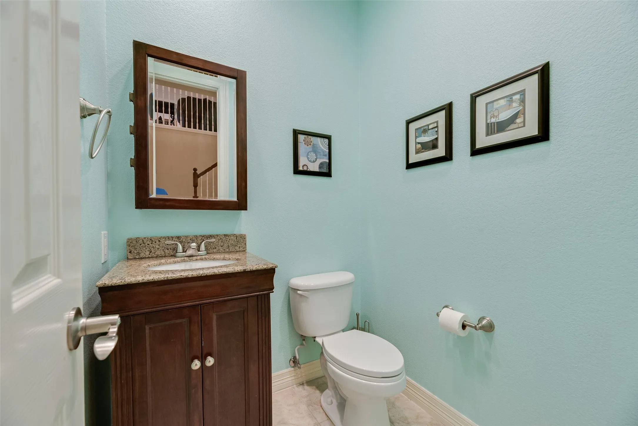 Built-in vanity with a granite-style countertop and undermount sink
