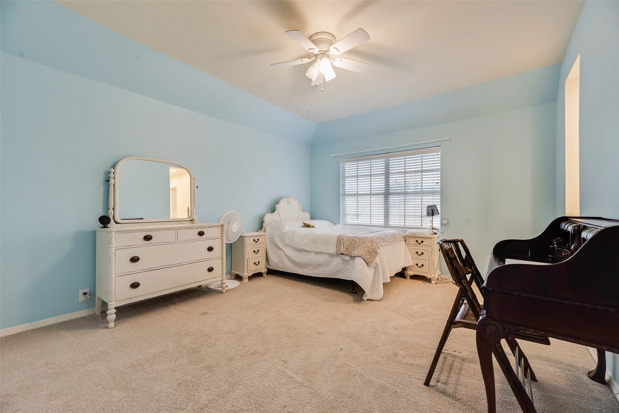 Carpet flooring, tray ceiling, ceiling fan, and window with blinds