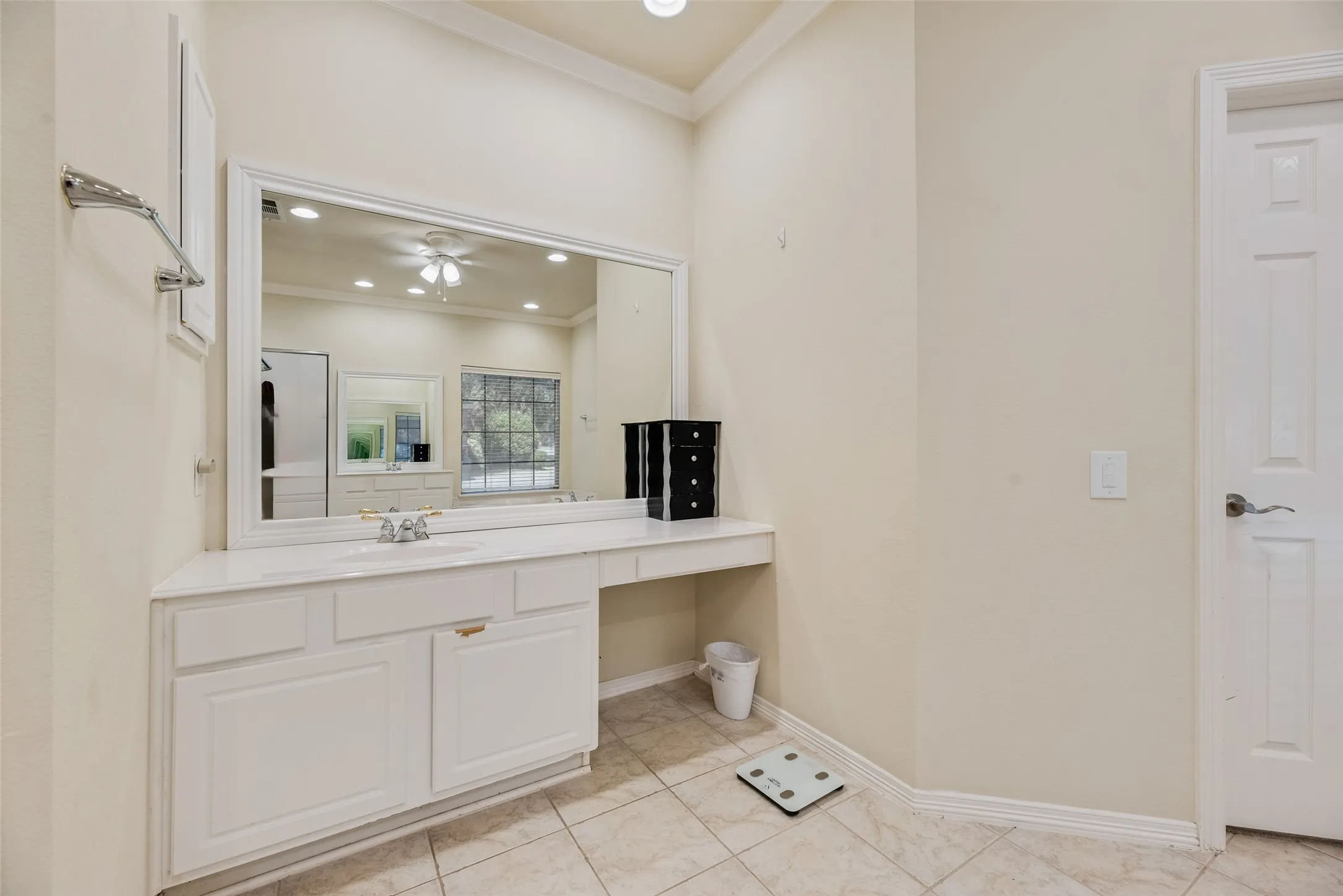 Spacious vanity with an integrated sink, expansive mirror, and dedicated makeup area