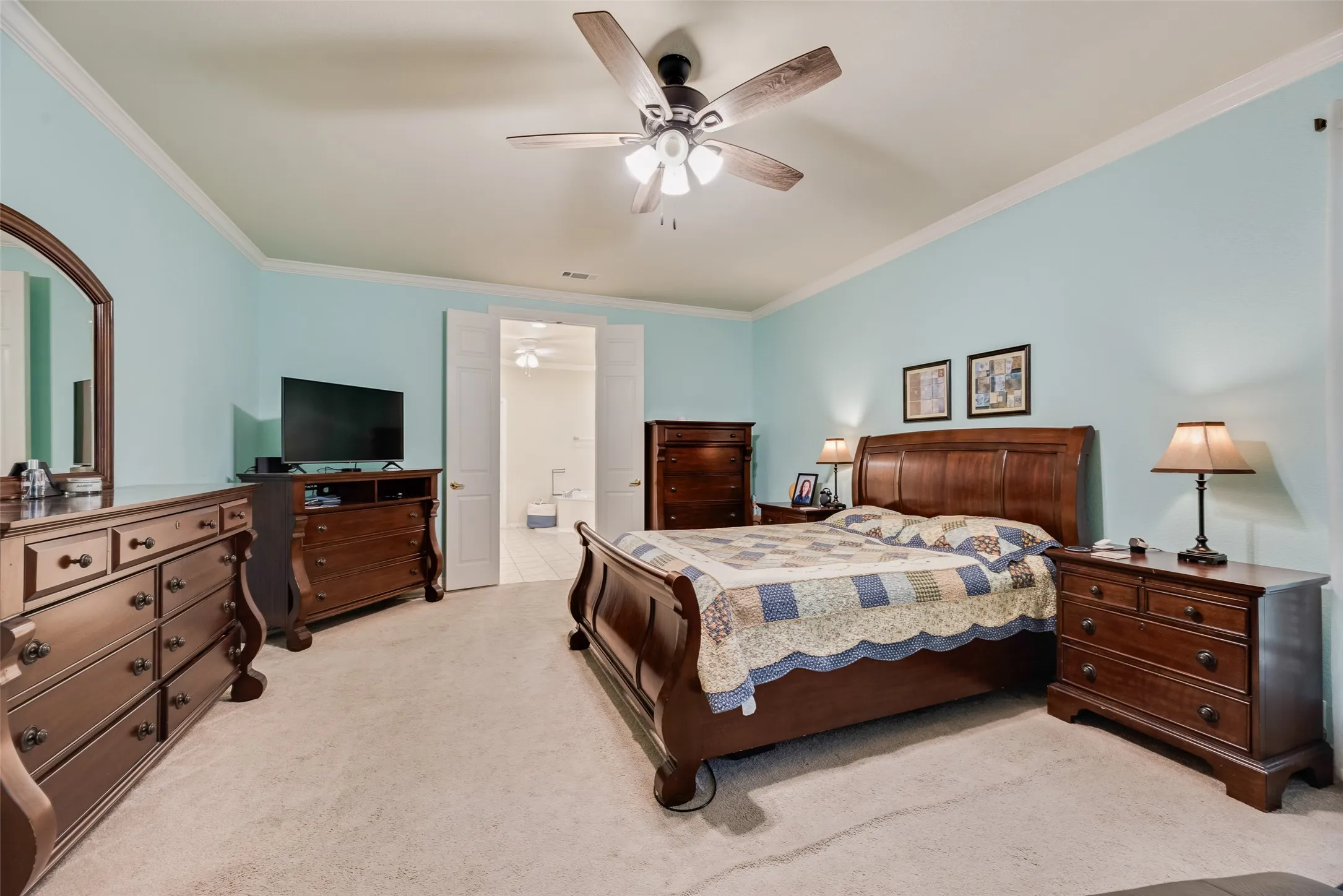 Recessed ceiling fan with light fixture, light-colored carpeting, crown molding, and double white paneled doors