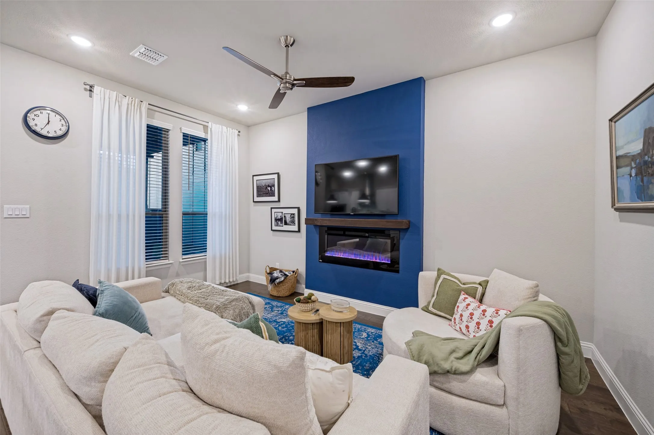 Recessed lighting, ceiling fan, wood-finish flooring, electric fireplace, and twin windows