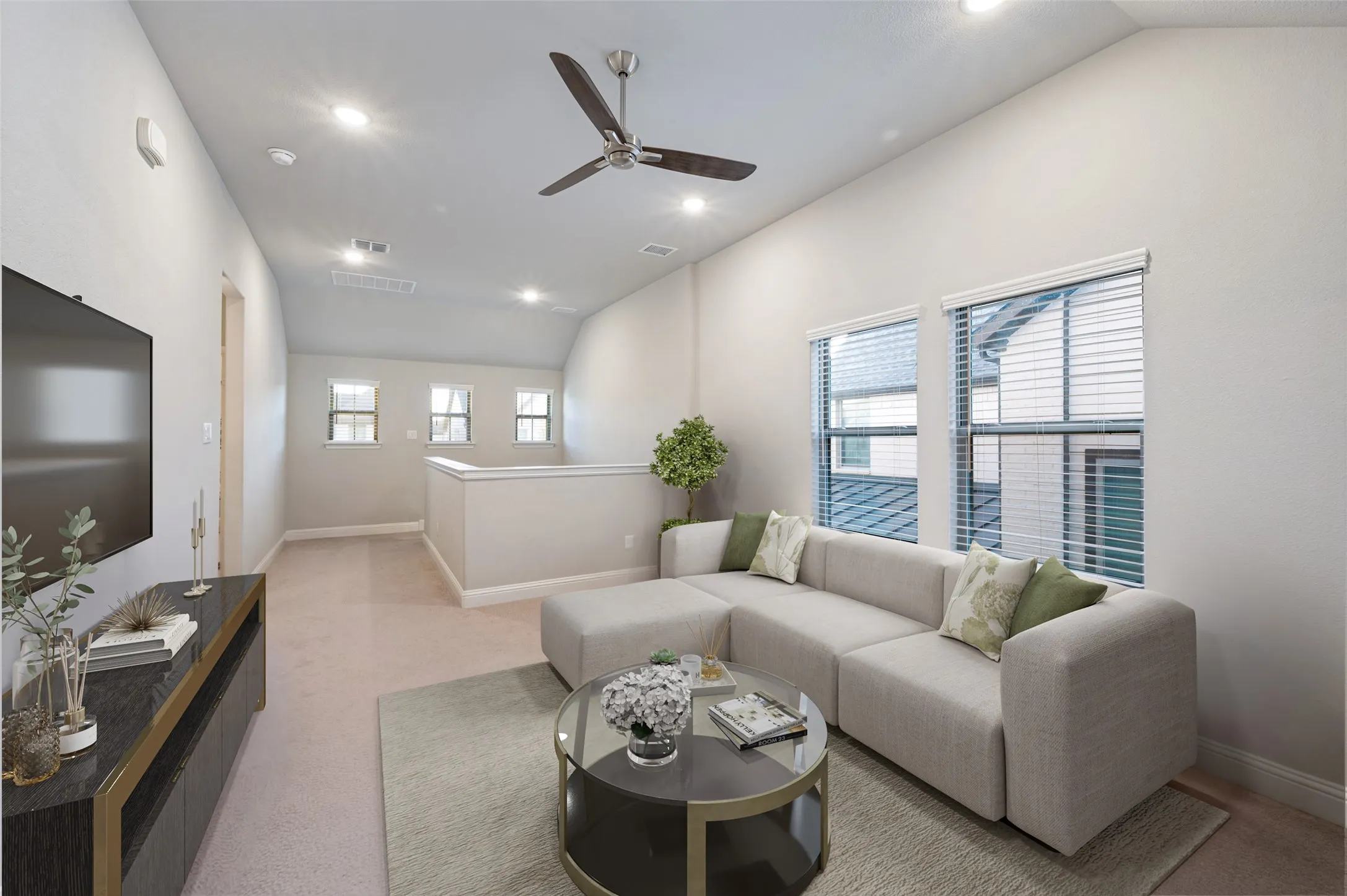Vaulted ceilings with recessed lighting and a ceiling fan. (Virtually Staged)