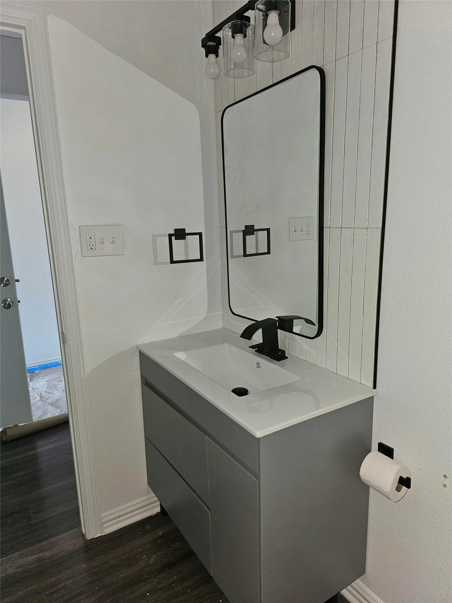 Floating vanity with a light gray finish and integrated rectangular sink