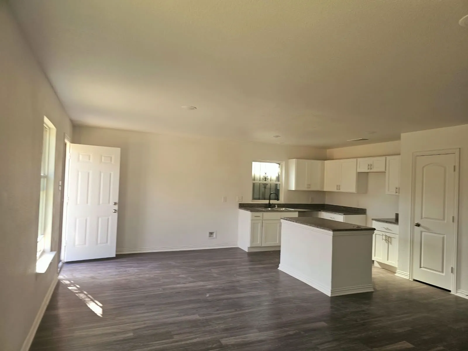 Spacious open-concept layout with wood-finish flooring