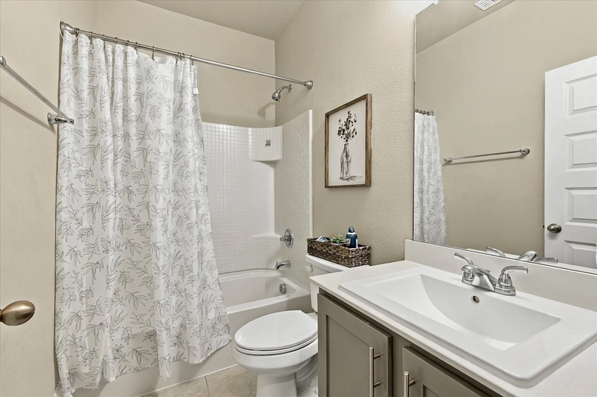 Full bathroom featuring a single vanity with storage, integrated sink, and chrome faucet