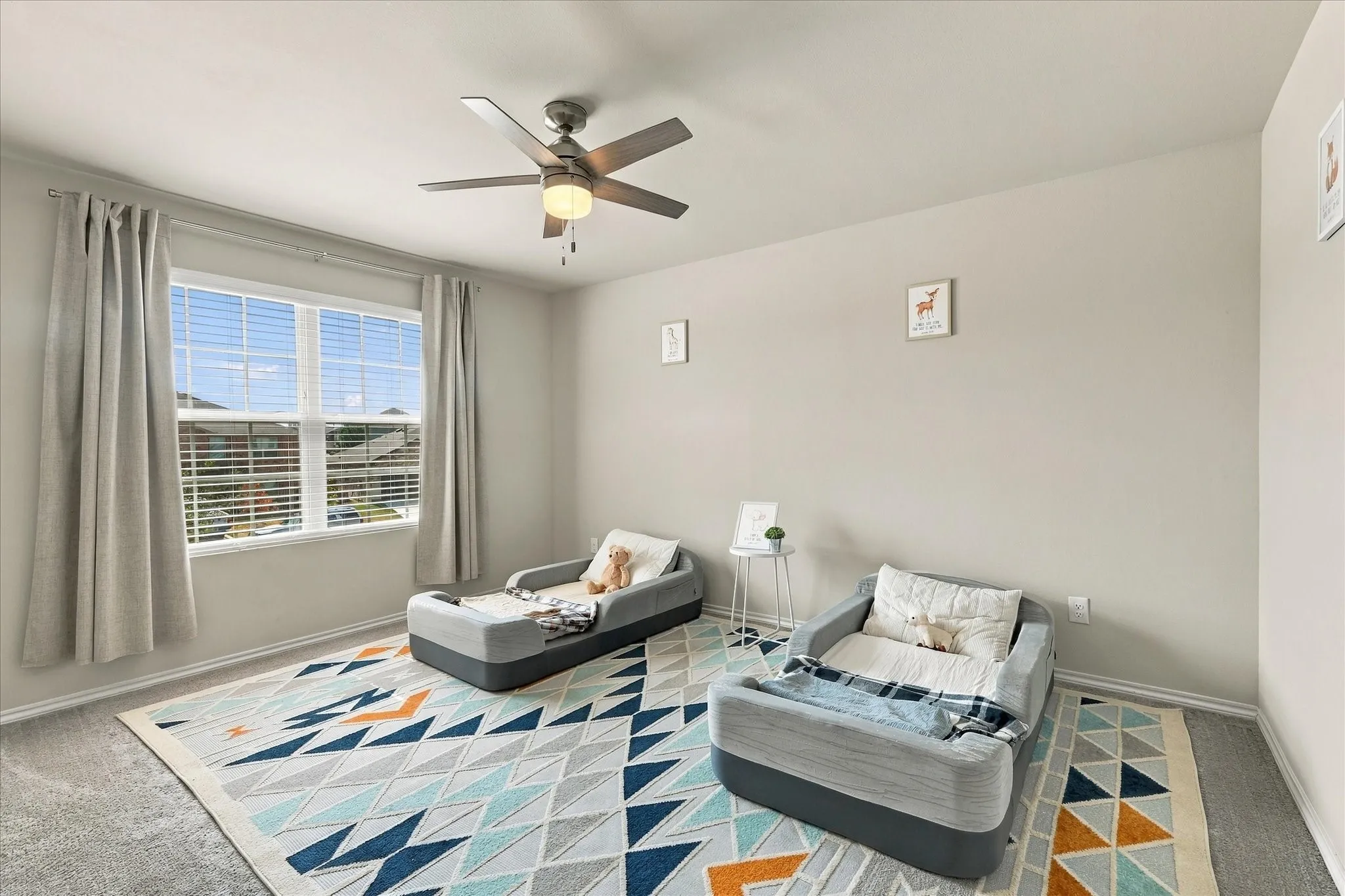 Window with horizontal blinds, overhead ceiling fan with lighting, light gray wall paint, and gray carpet