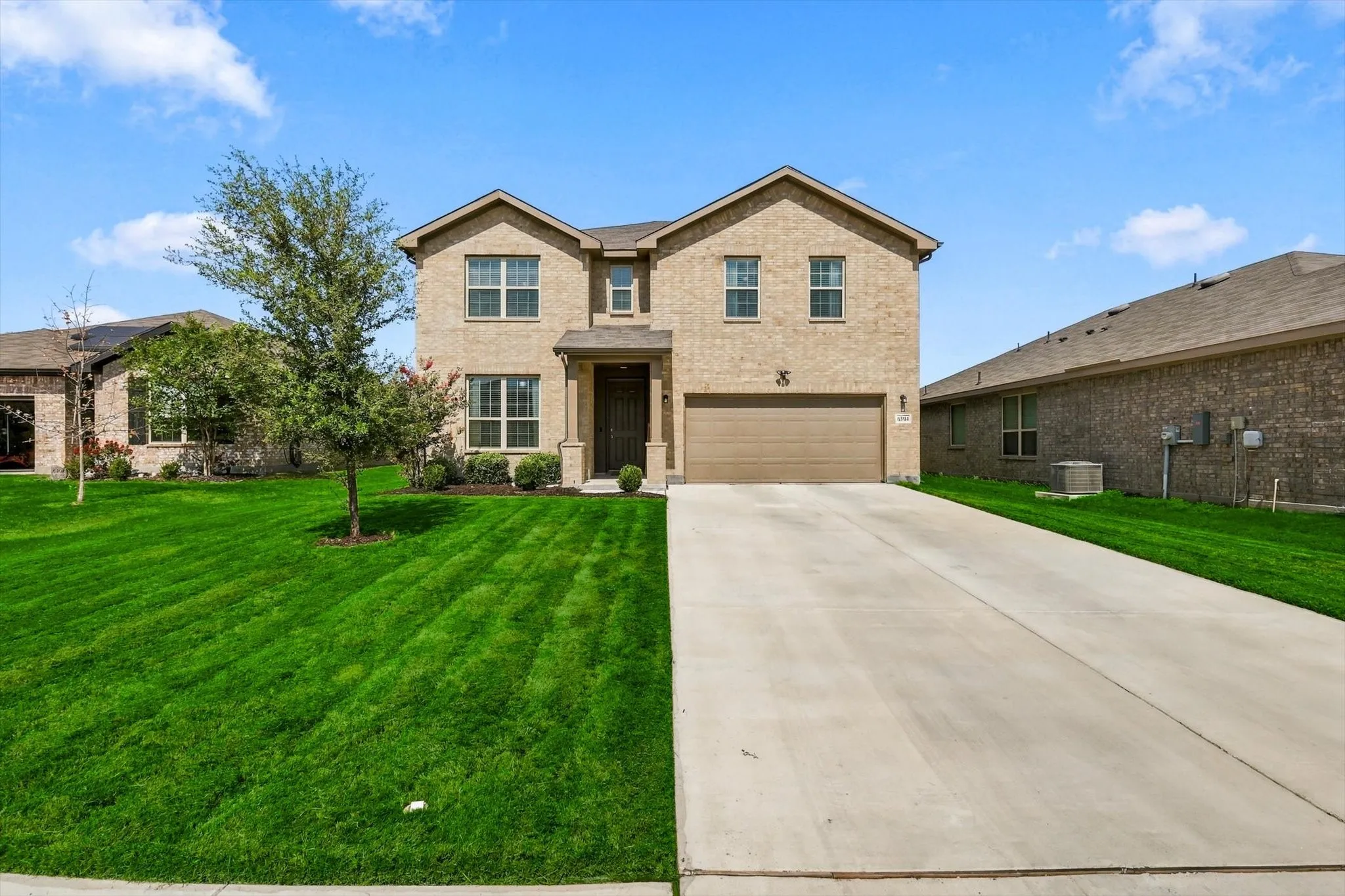 Brick exterior with a gabled roof and attached garage