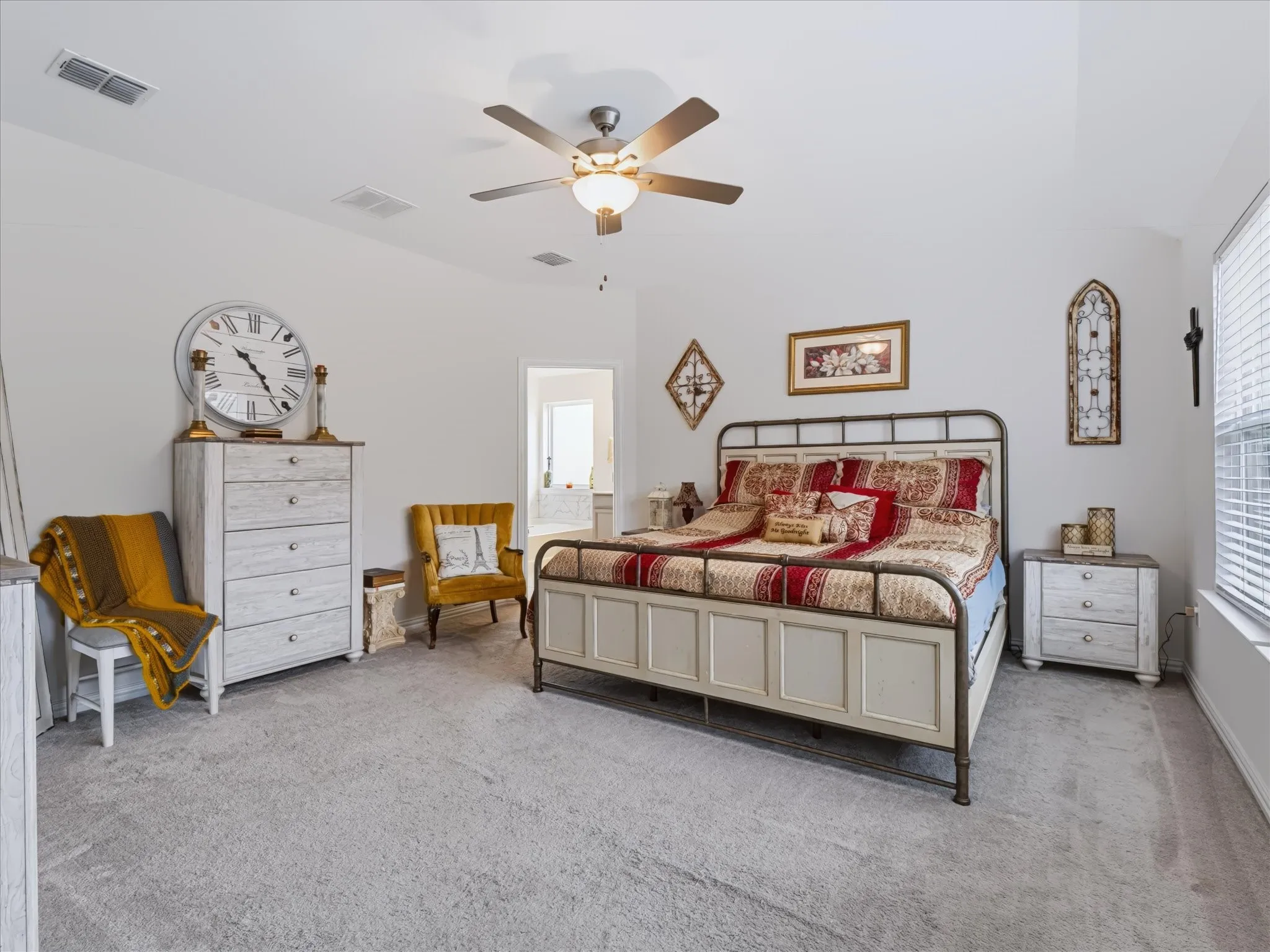 Vaulted ceiling, ceiling fan with integrated lighting, window with blinds, carpet flooring, recessed doorway