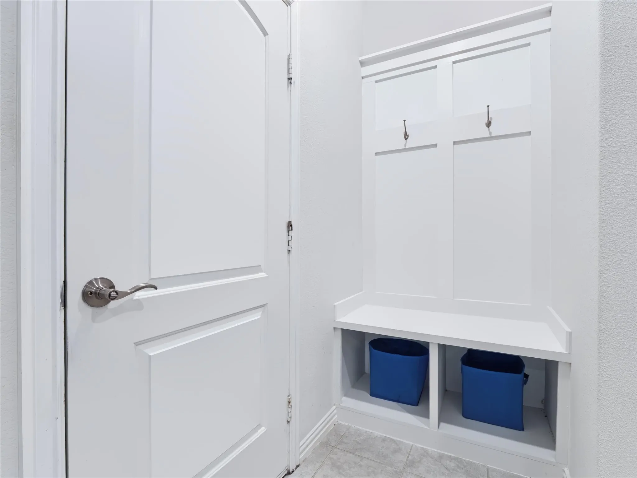 Built-in mudroom bench with coat hooks and storage cubbies