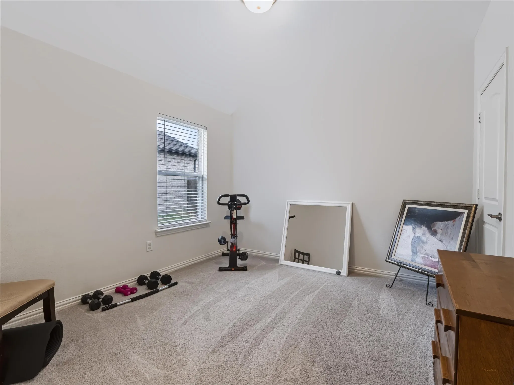 Neutral paint palette, carpet flooring, window with blinds, and white trim