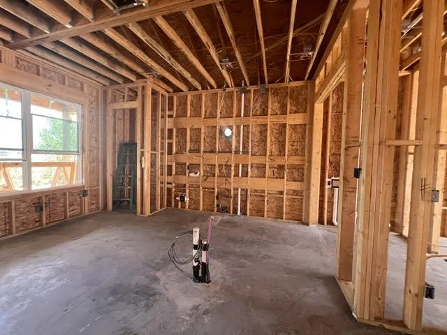 Standing in the living room looking into the kitchen area