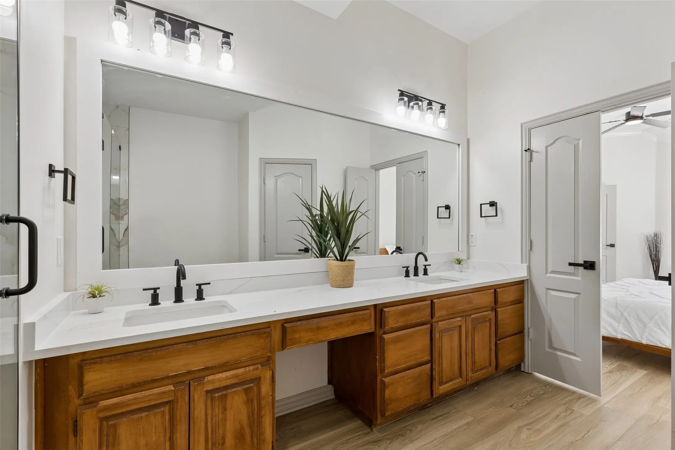 Dual vanity with white countertops, undermount sinks, and matte black fixtures