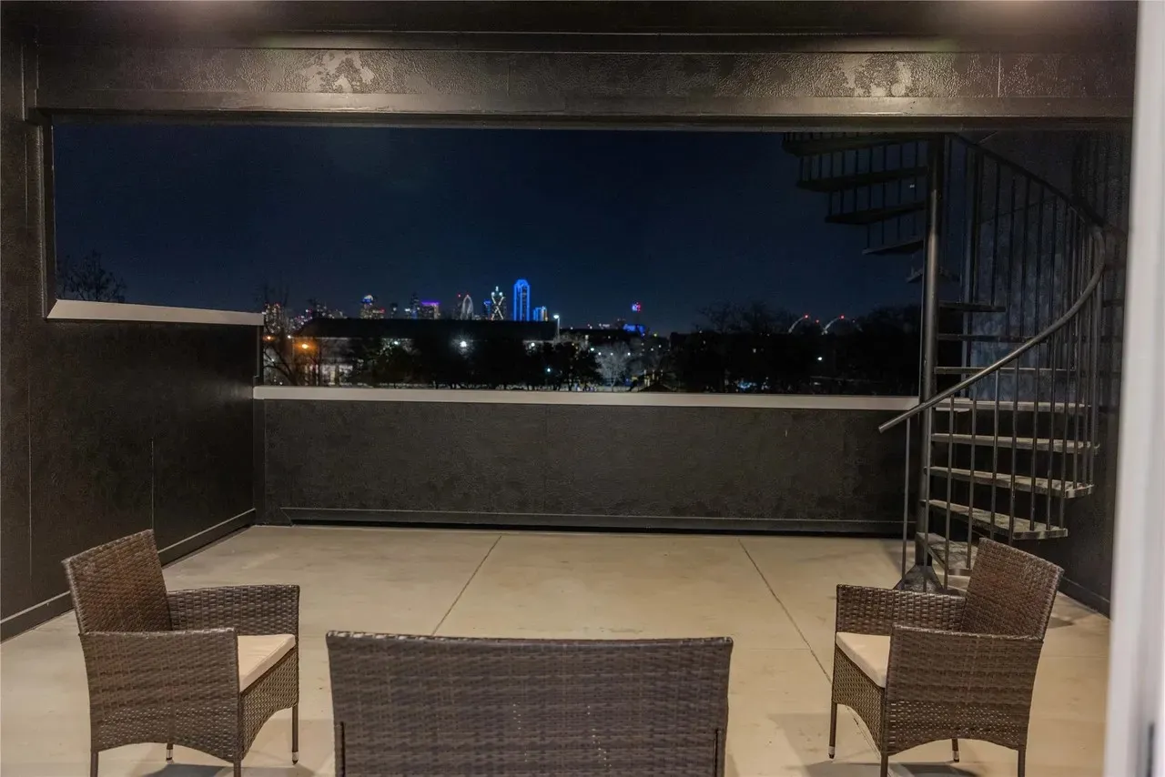 Rooftop deck featuring a metal spiral staircase and panoramic cityscape