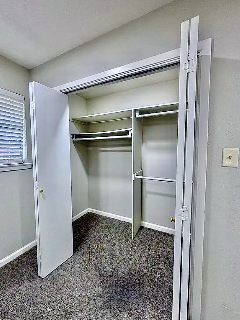 Built-in closet system with shelving and hanging rods