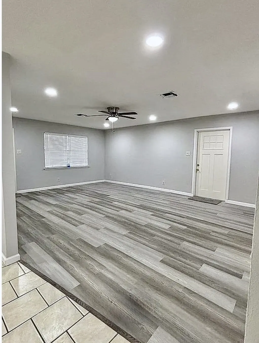 Spacious room featuring wood-finish flooring, recessed lighting, and a ceiling fan