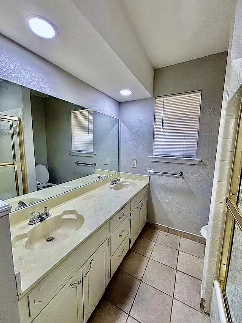 Dual vanity with integrated sinks, ample countertop space, and under-cabinet storage