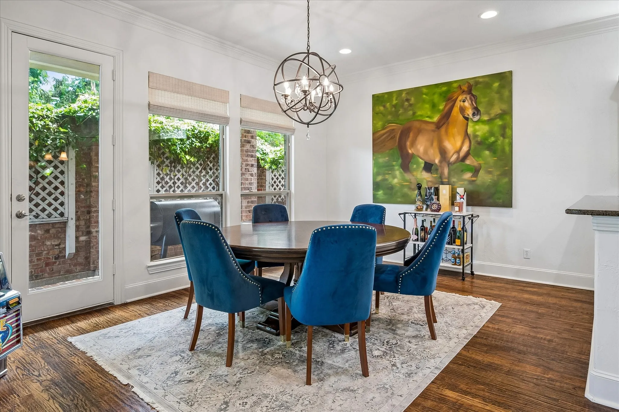Hardwood flooring, recessed lighting, and a drum pendant light fixture with an orb design
