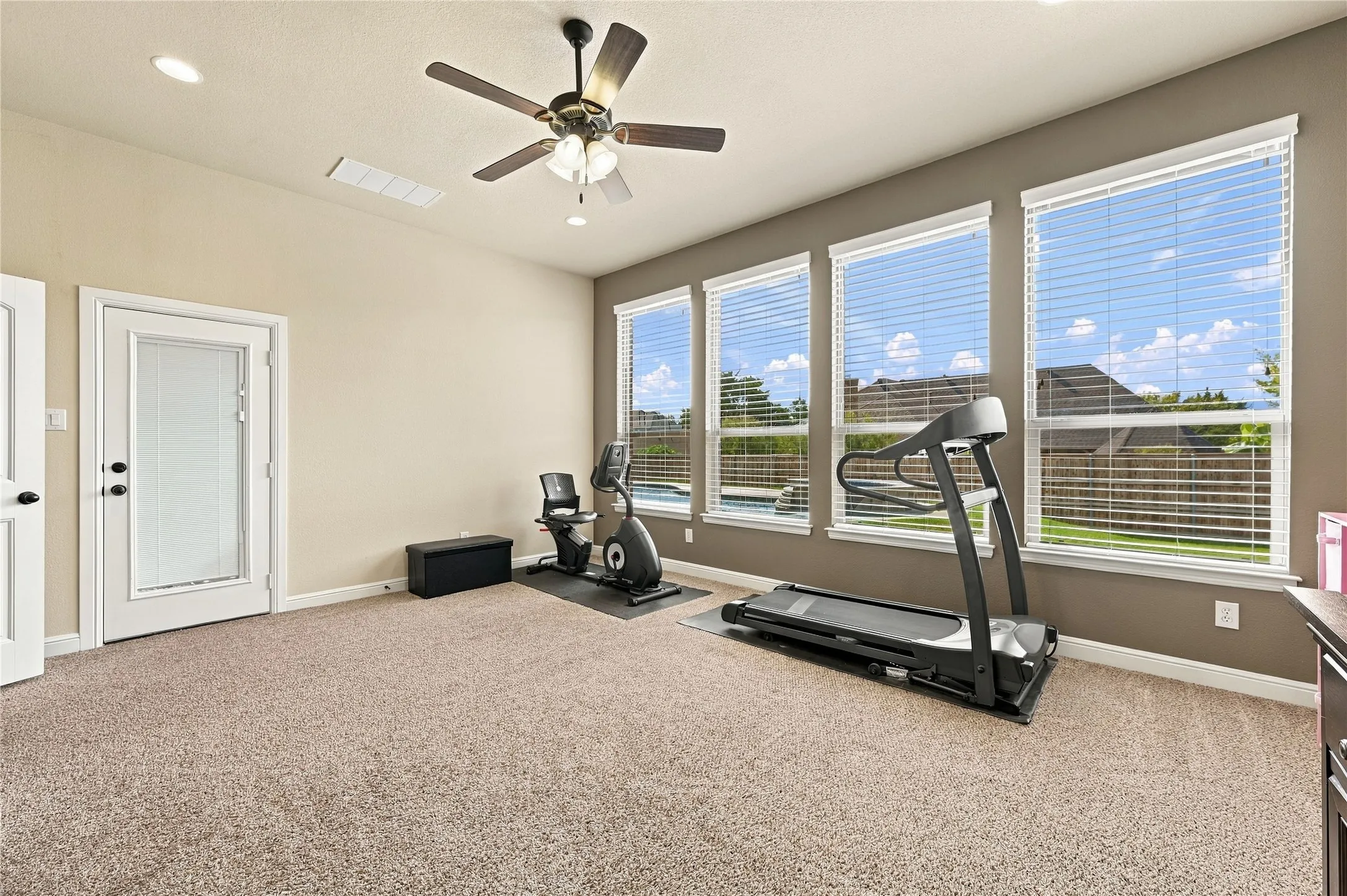 Large game room with closet and door to patio