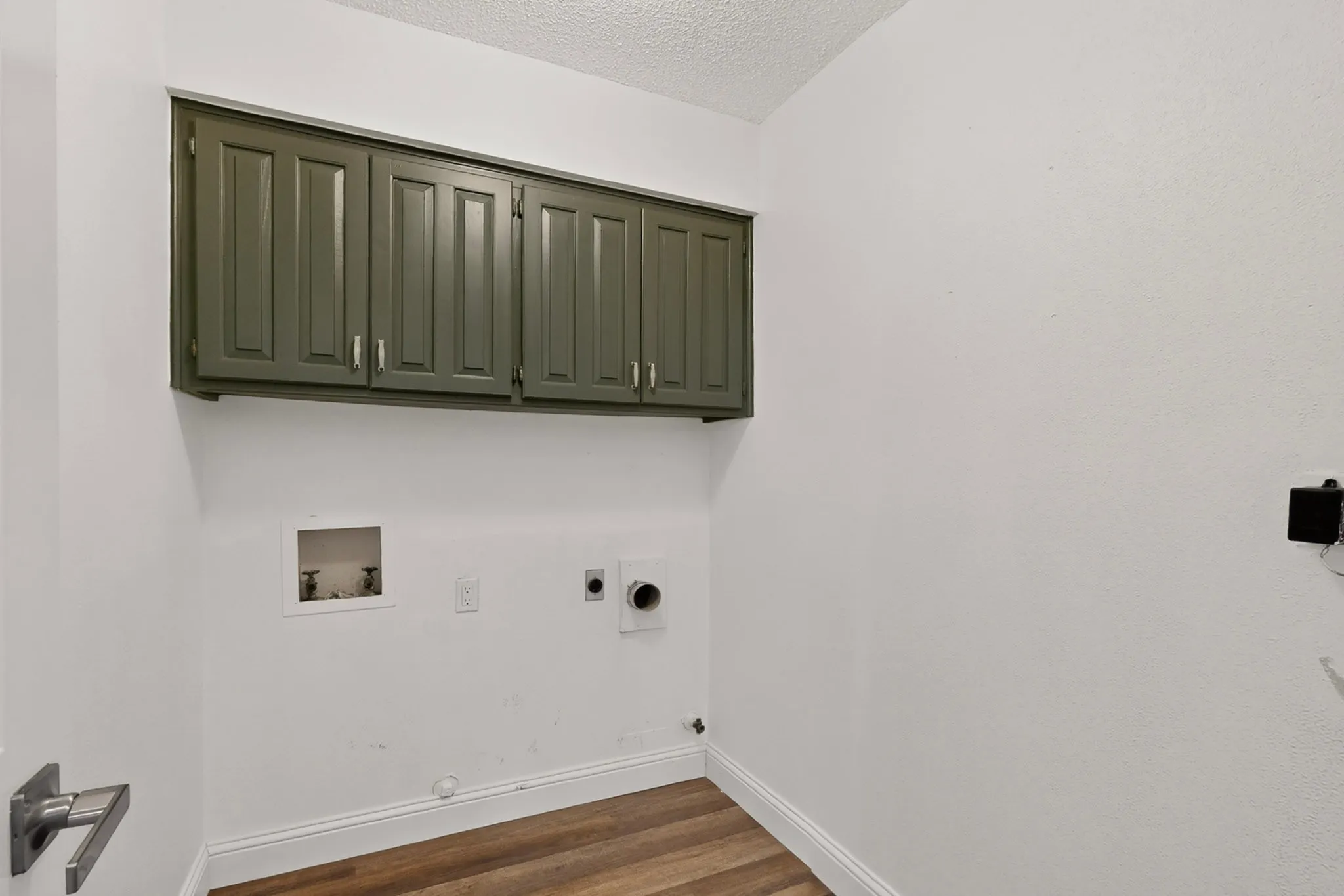 Wood-finish flooring with white baseboards