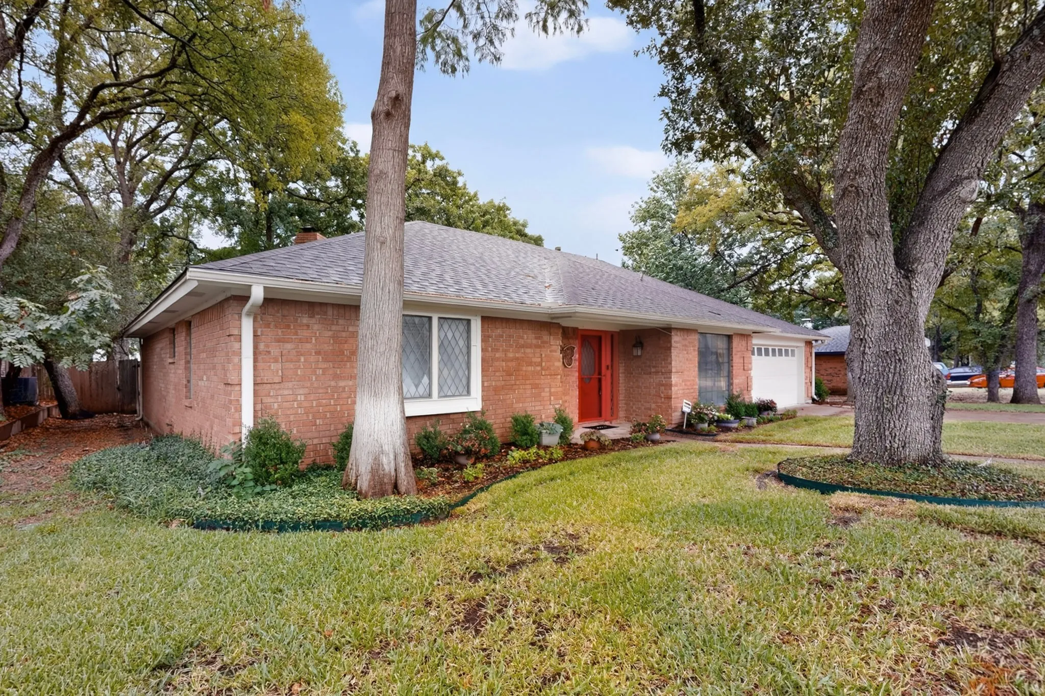 Brick exterior with a gabled roof and attached garage