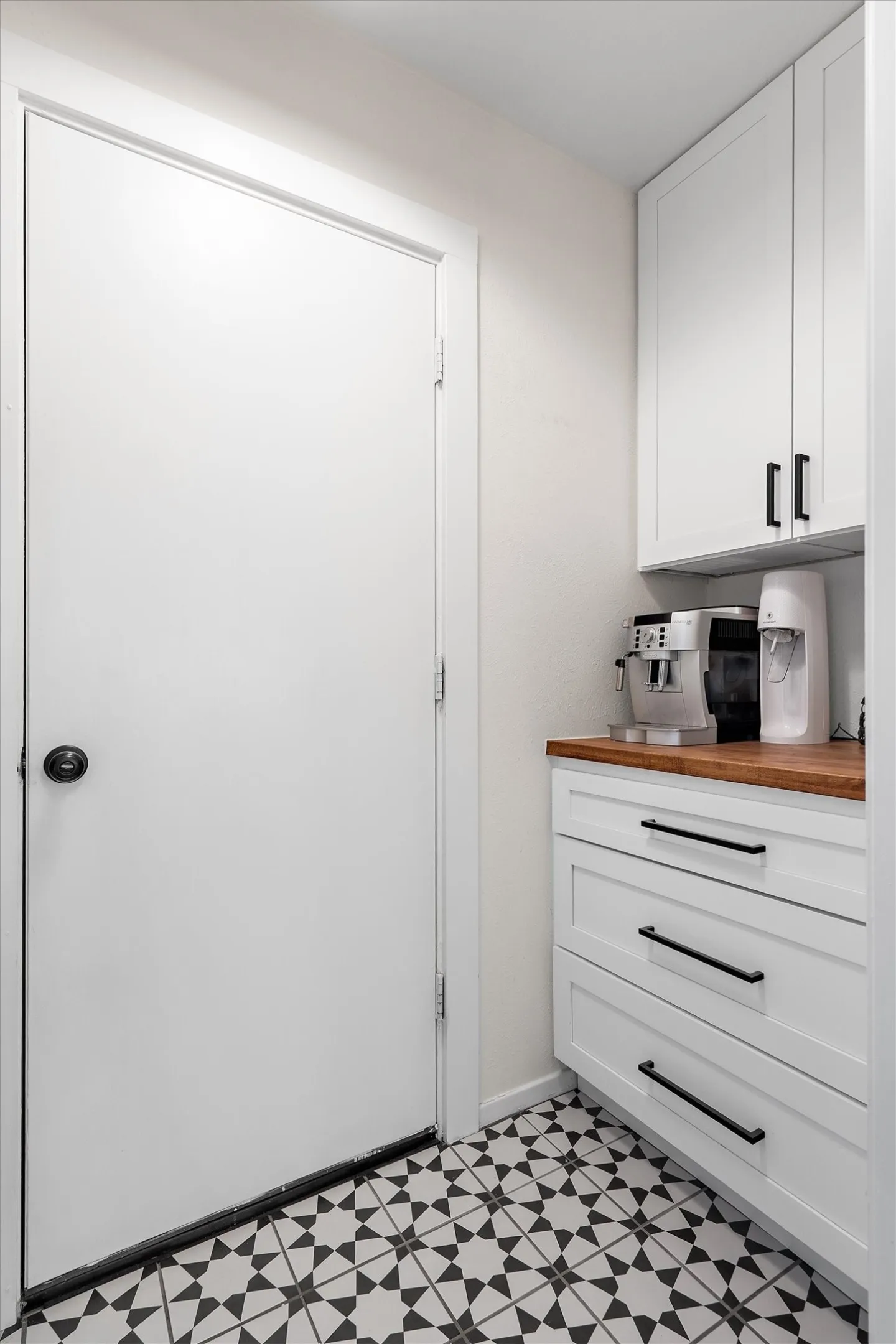 Laundry room has extra storage and counter space.