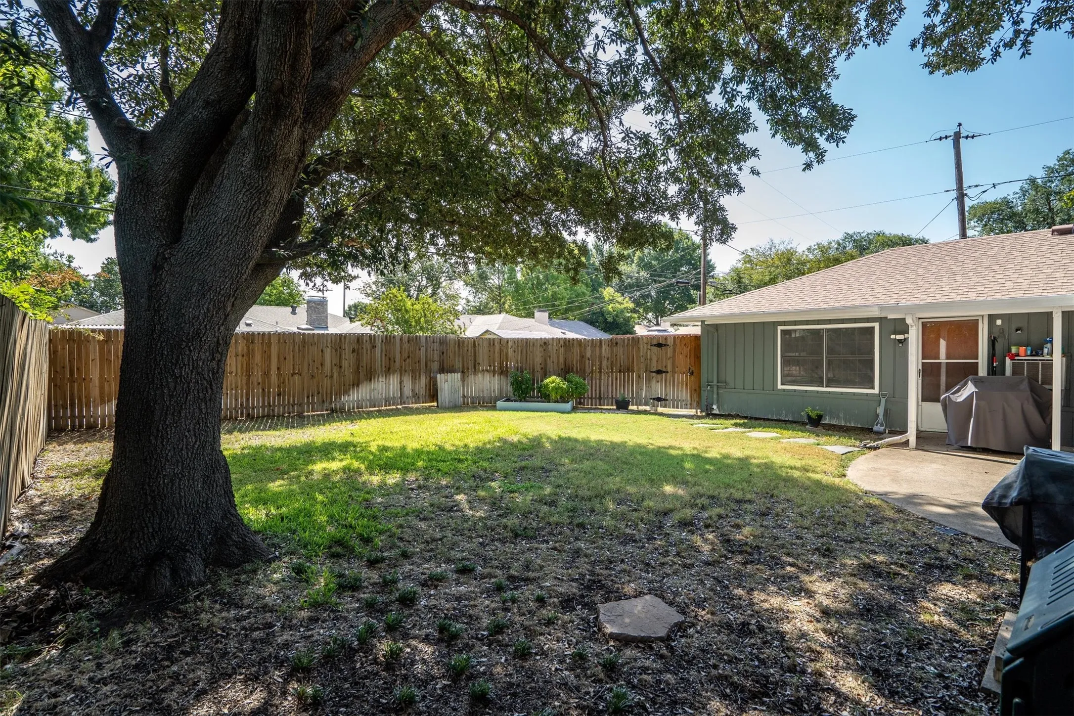 Enjoy privacy and shade from a mature tree.