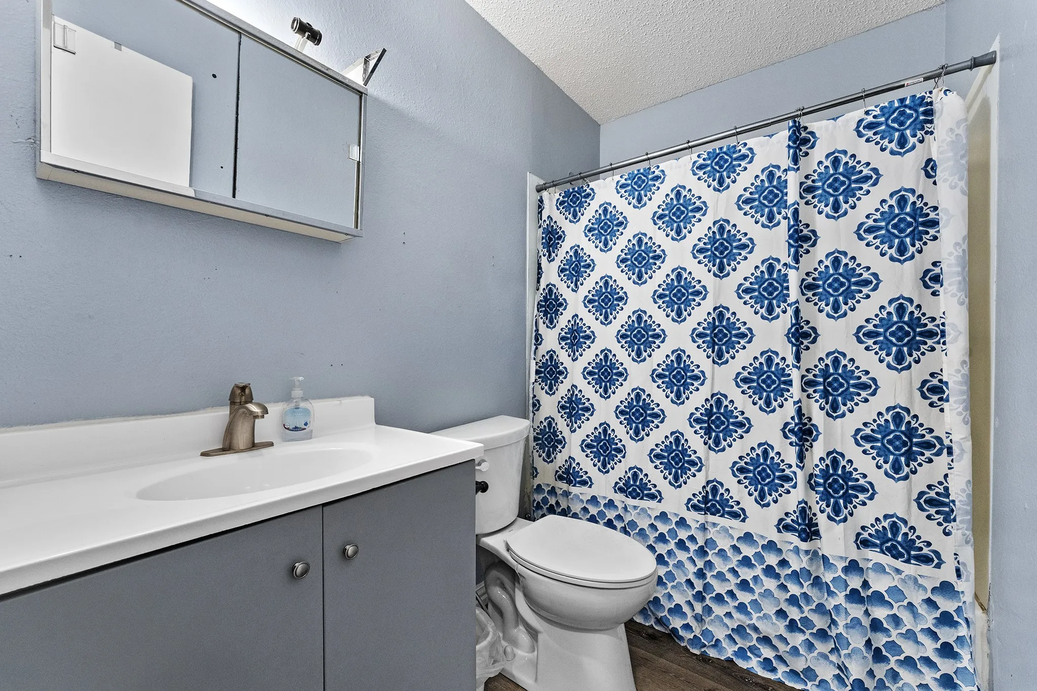 Vanity with integrated sink, sleek faucet, and under-cabinet storage