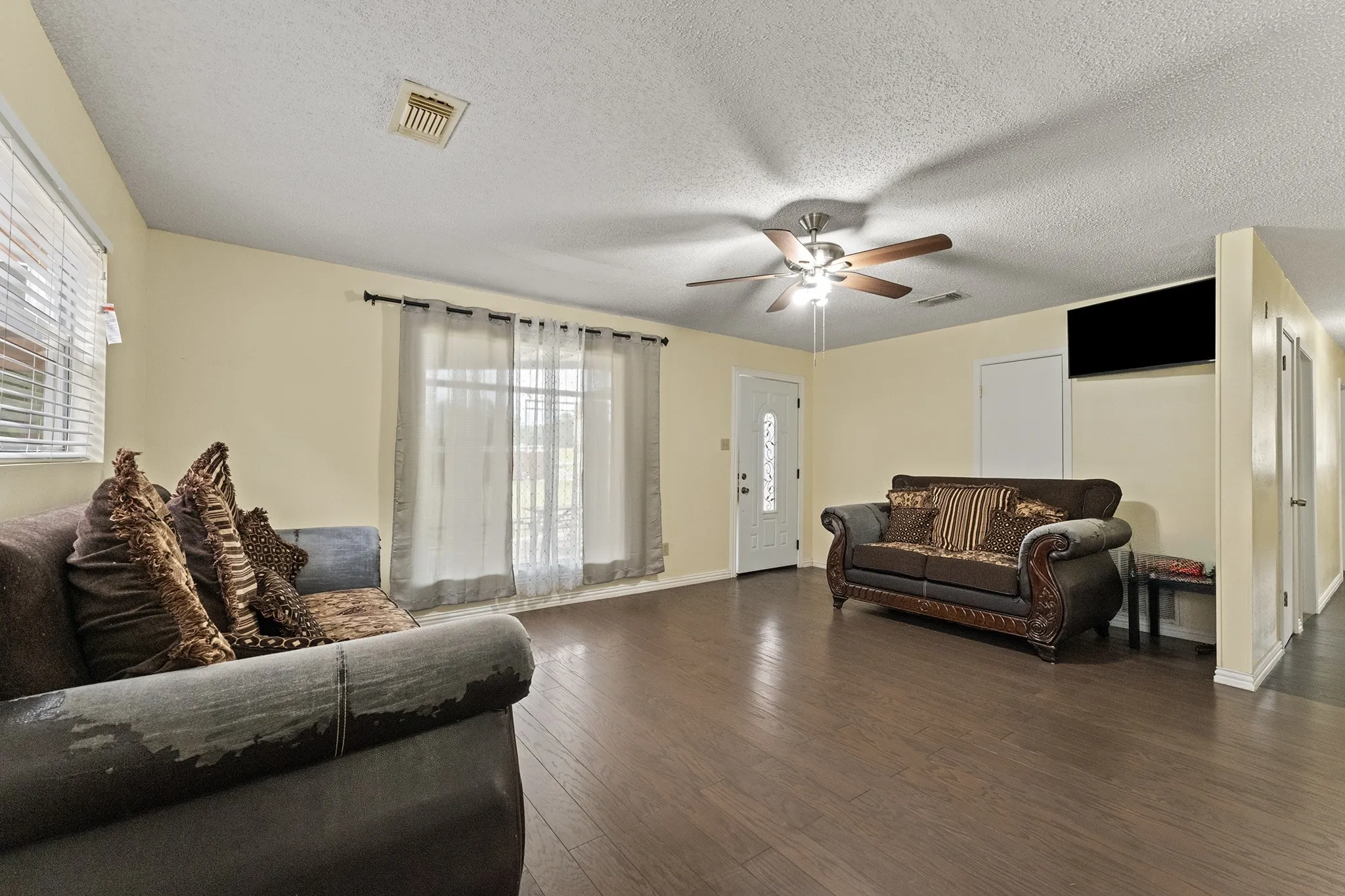 Wood-finish flooring throughout, paired with light-toned walls