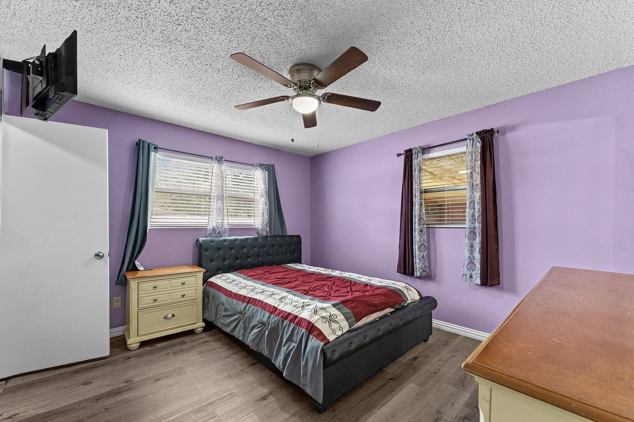 Wood-finish flooring with a ceiling-mounted fan fixture
