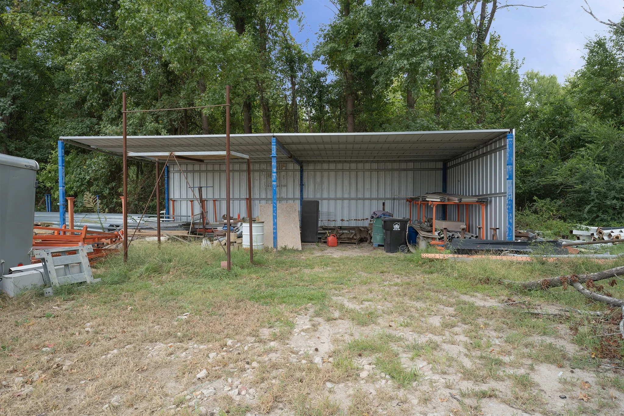 Covered storage structure with metal panel walls and roof