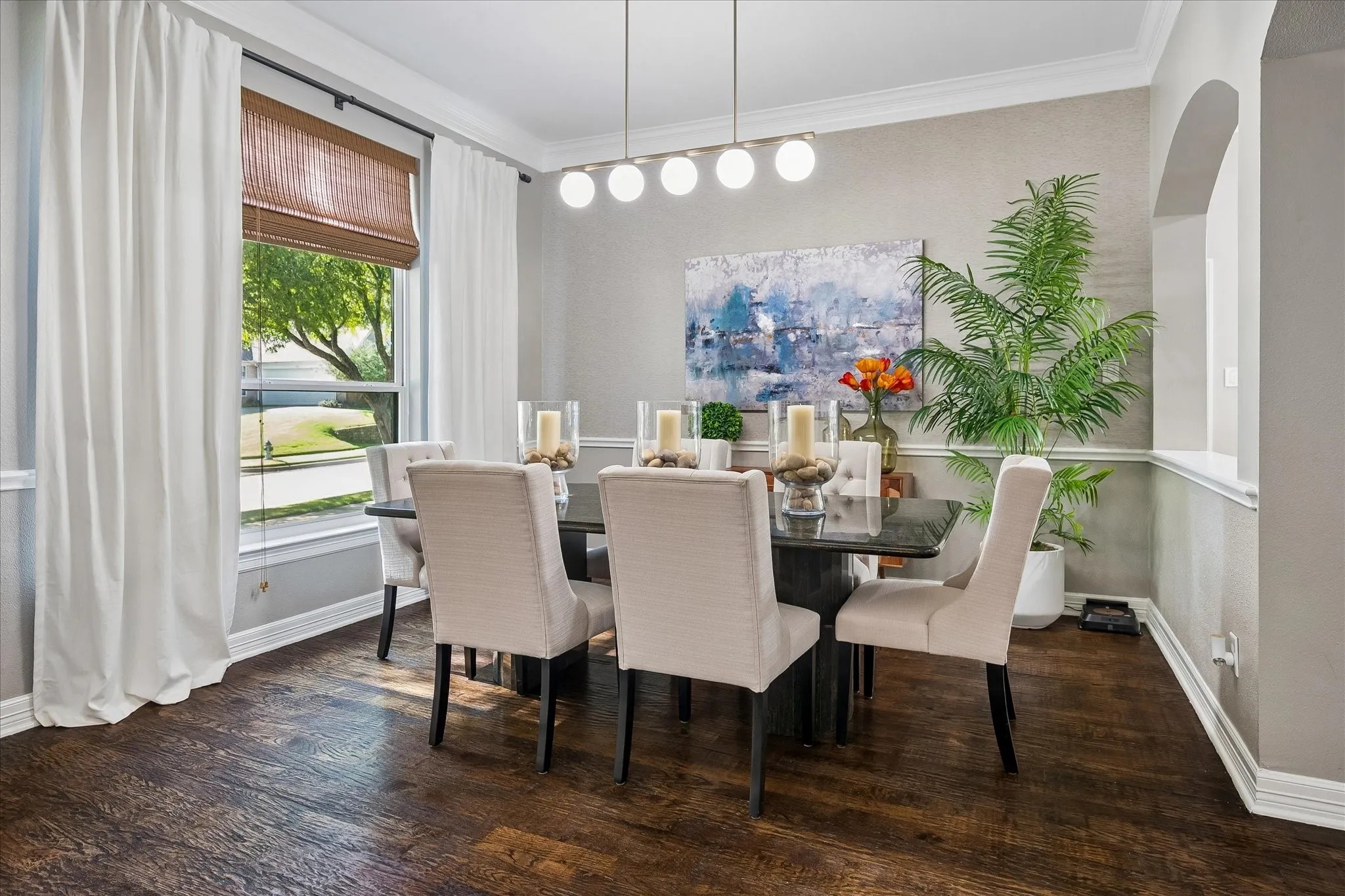 Wood-finish flooring throughout, complemented by crown molding and wainscoting