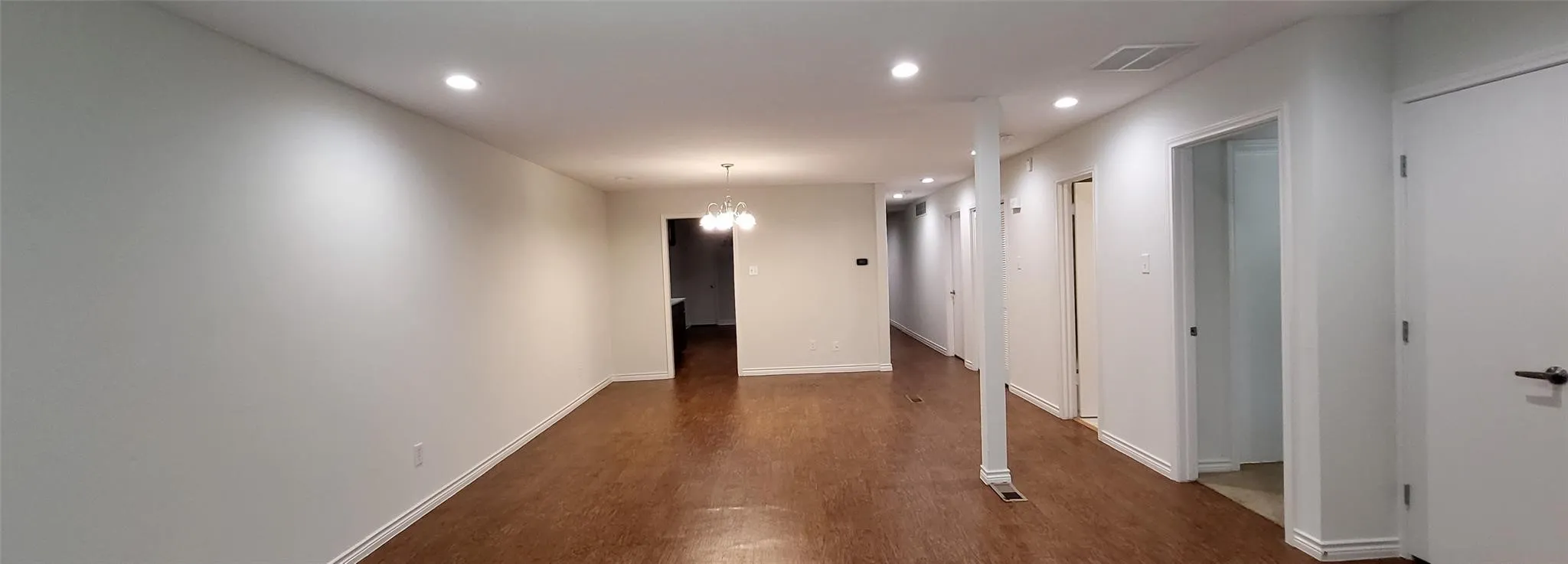 Open living-dining stretch in fresh neutral paint