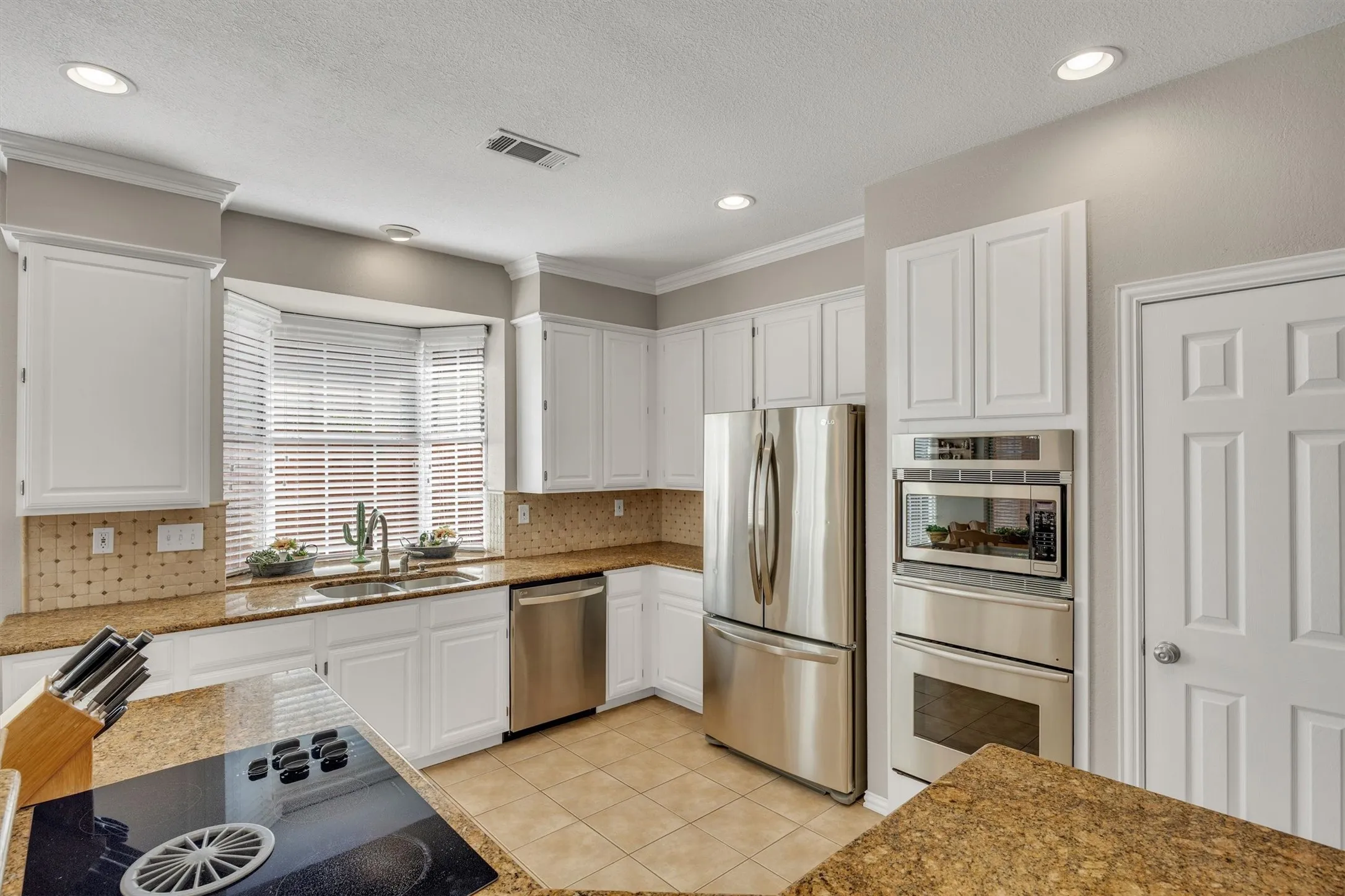 Stainless steel appliances include dishwasher, microwave, warming drawer and convection oven.