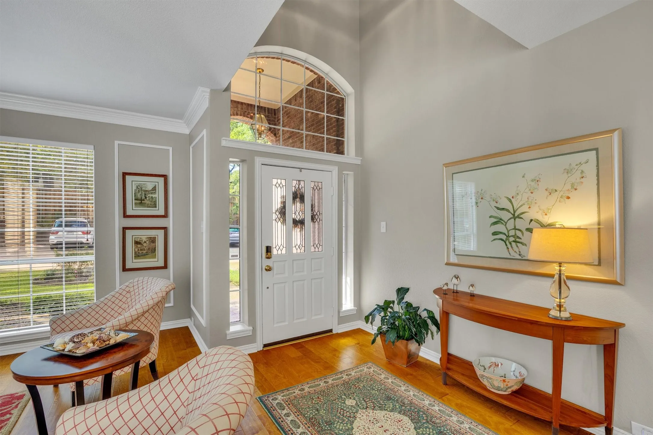 Two story foyer entrance looks to the upstairs catwalk and through to the back of the house.